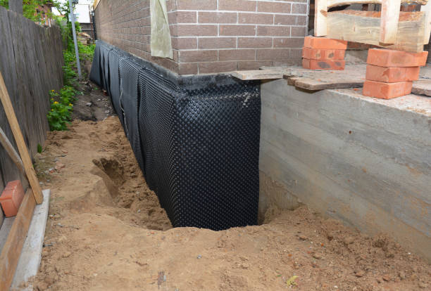 Happy homeowners after waterproofing job in Manville